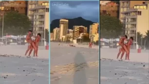 Pareja disfrutando del sol y la playa de Miami en un acto íntimo al aire libre