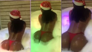 Vanessa Rodrigues con gorro de Papá Noel bailando con su culo curvilíneo en una bañera llena de espuma